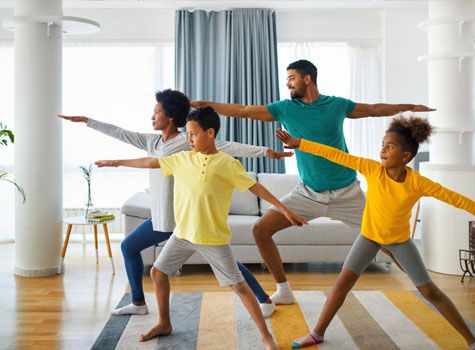 A family exercising together at home.