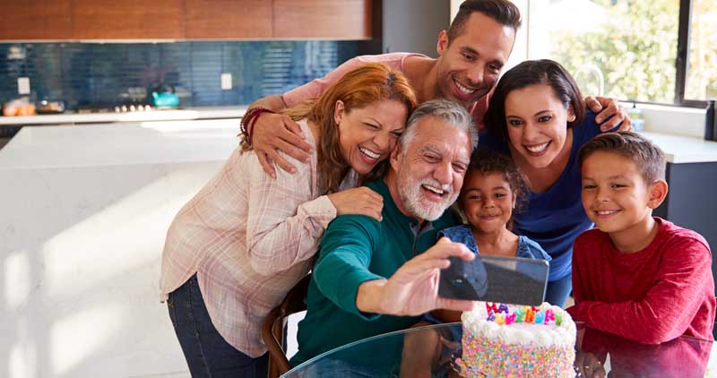 A multi-generational family celebrating a birthday at home.